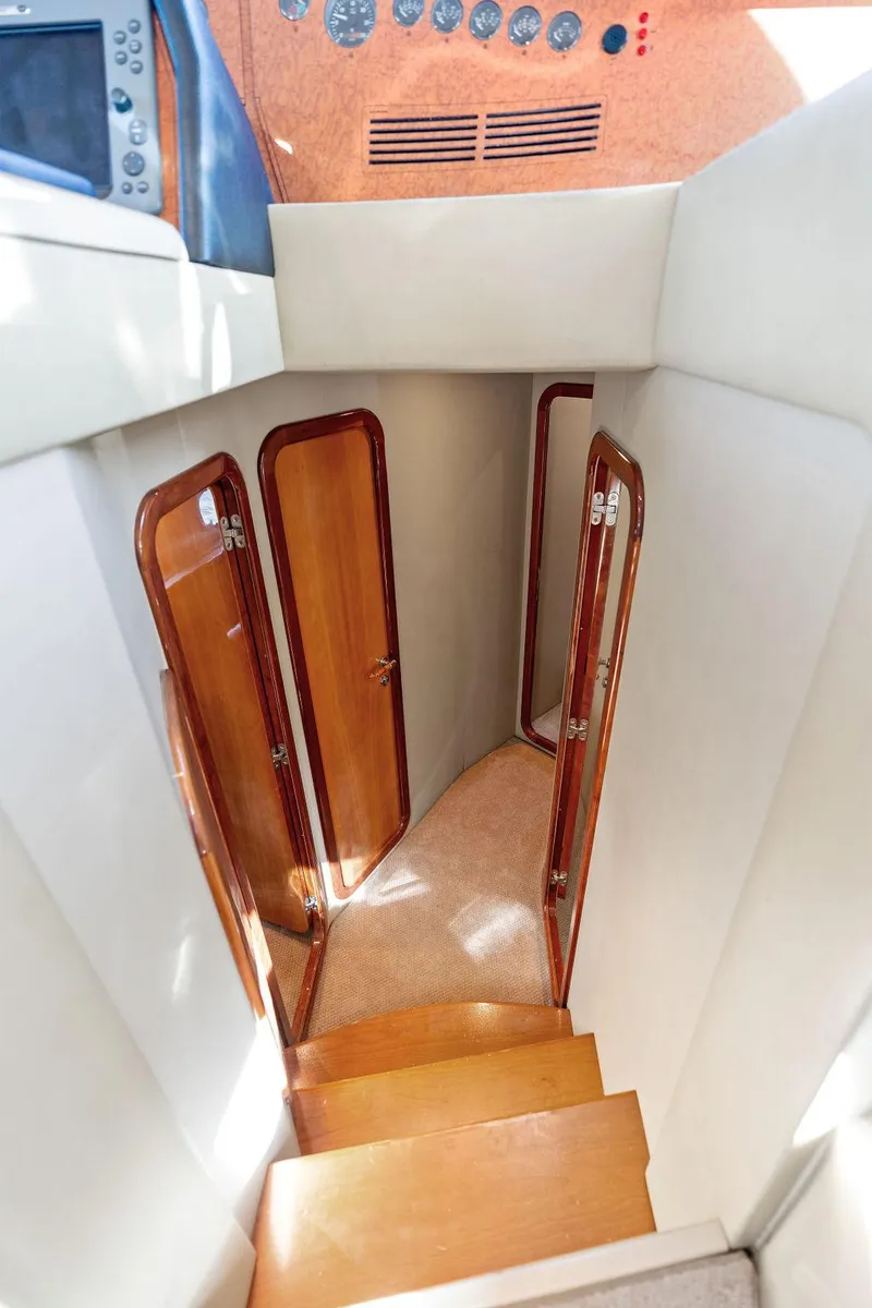 Slide: The Image of Interior staircase of 2003 Ferretti Yachts 620 with wooden doors and carpeted steps. - 28