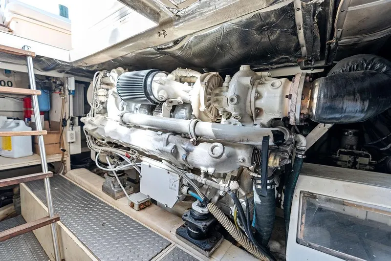 Slide: The Image of Engine room of 2003 Ferretti Yachts 620, showcasing powerful marine engine components. - 48