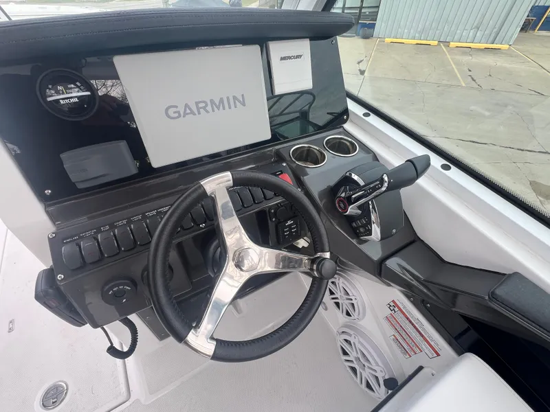 Slide: The Image of 2024 Blackfin 252 DC boat dashboard with Garmin display and steering wheel. - 10