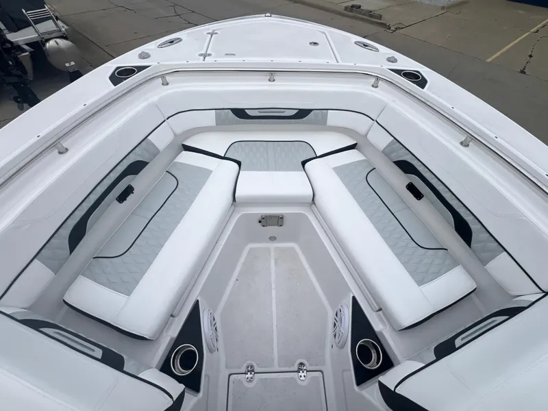 Slide: The Image of 2024 Blackfin 252 DC boat interior with white cushioned seating and sleek design. - 11