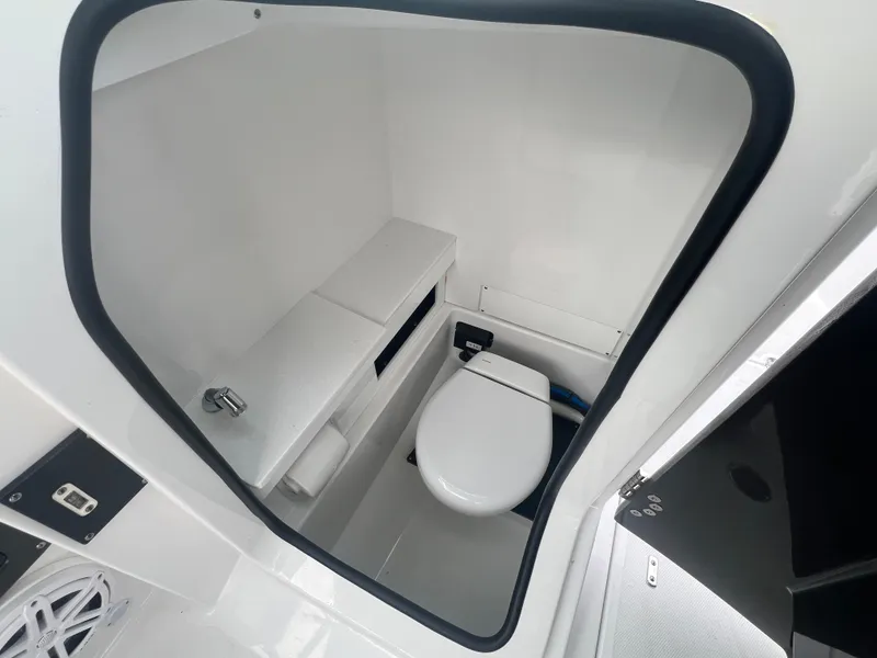 Slide: The Image of 2024 Blackfin 252 DC boat interior bathroom with modern white fixtures. - 12