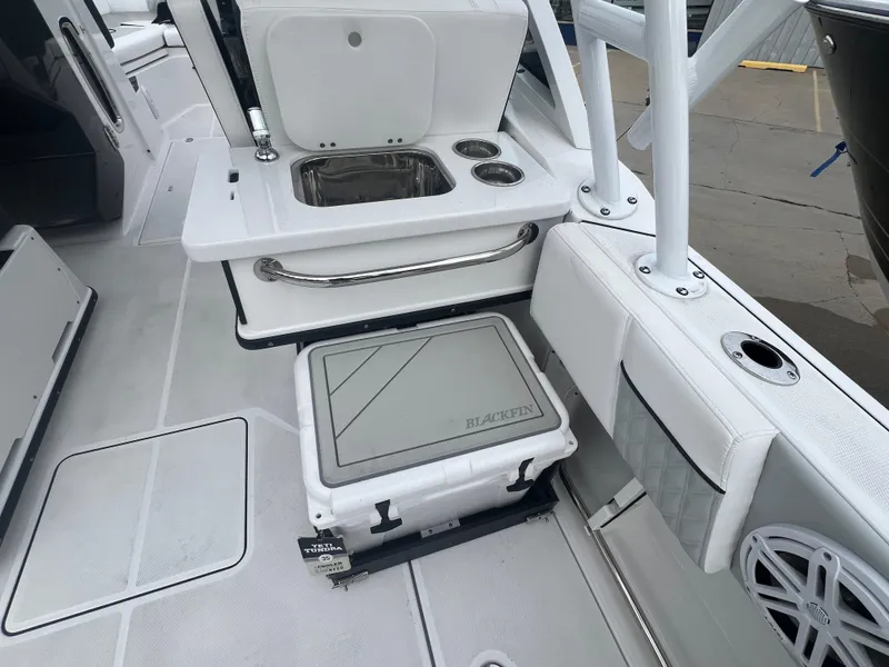 Slide: The Image of 2024 Blackfin 252 DC boat interior with seating, sink, and cooler. - 5