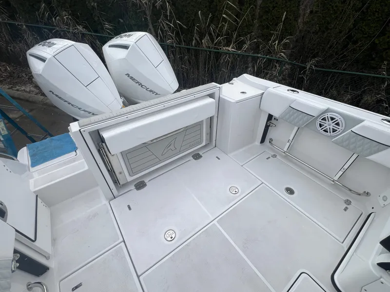 Slide: The Image of 2024 Blackfin 252 DC boat deck with twin Mercury engines. - 6