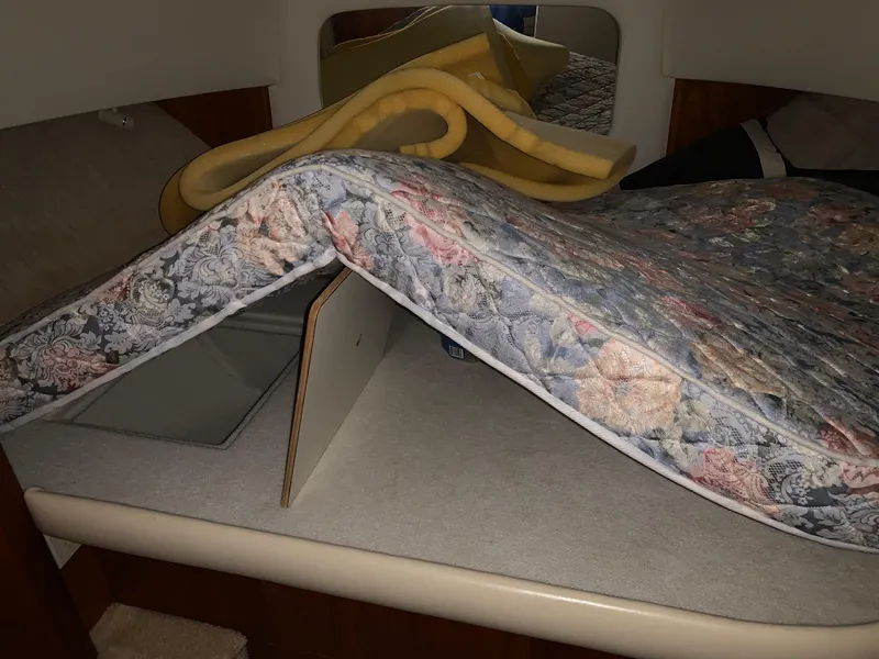 Slide: The Image of 2000 Silverton 392 Motor Yacht interior with floral mattress and foam padding. - 10