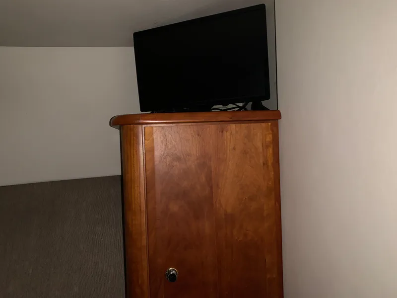 Slide: The Image of Wooden cabinet with a TV on top inside a 2000 Silverton 392 Motor Yacht. - 11