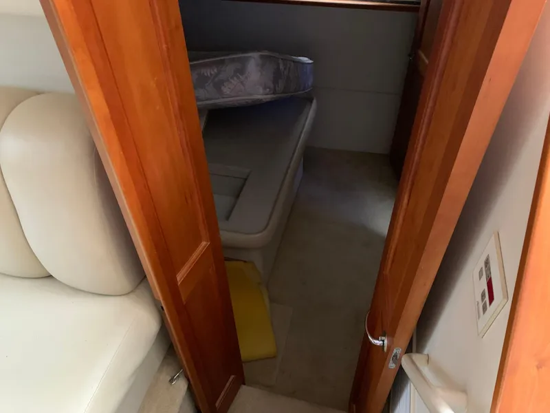 Slide: The Image of Interior cabin view of a 2000 Silverton 392 Motor Yacht, featuring a cozy sleeping area. - 13