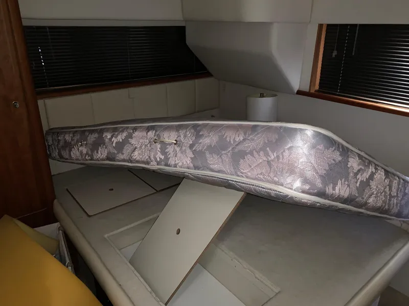 Slide: The Image of Interior of 2000 Silverton 392 Motor Yacht with mattress and storage compartments. - 14