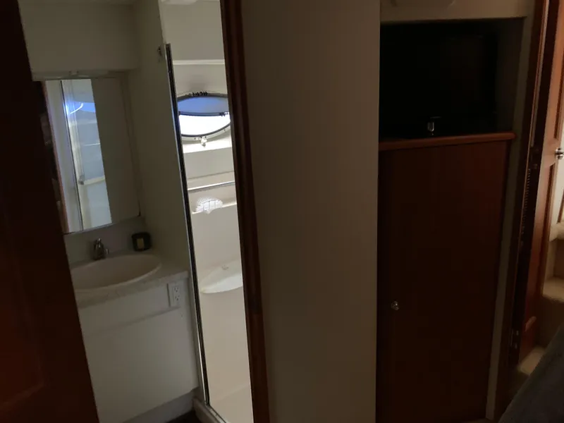 Slide: The Image of Interior of 2000 Silverton 392 Motor Yacht showing bathroom and storage area. - 15