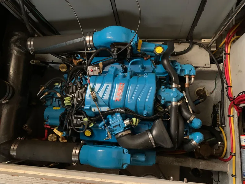 Slide: The Image of Engine of a 2000 Silverton 392 Motor Yacht, featuring blue components and black hoses. - 19