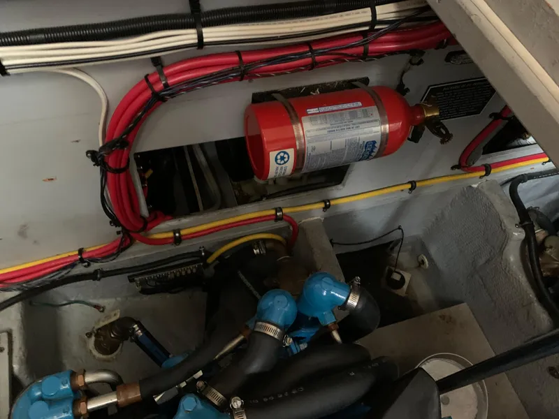 Slide: The Image of Engine room of 2000 Silverton 392 Motor Yacht with fire extinguisher and wiring. - 21