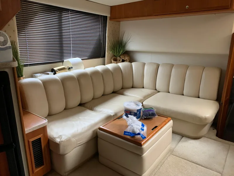 Slide: The Image of Interior of 2000 Silverton 392 Motor Yacht with beige leather seating and wooden accents. - 4