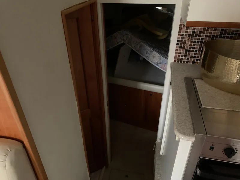 Slide: The Image of Interior view of 2000 Silverton 392 Motor Yacht cabin with bed and kitchenette. - 7