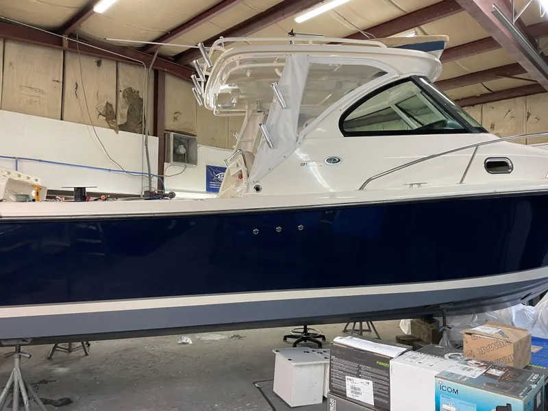 Slide: The Image of 2012 Pursuit 315 Offshore boat in a workshop setting. - 26