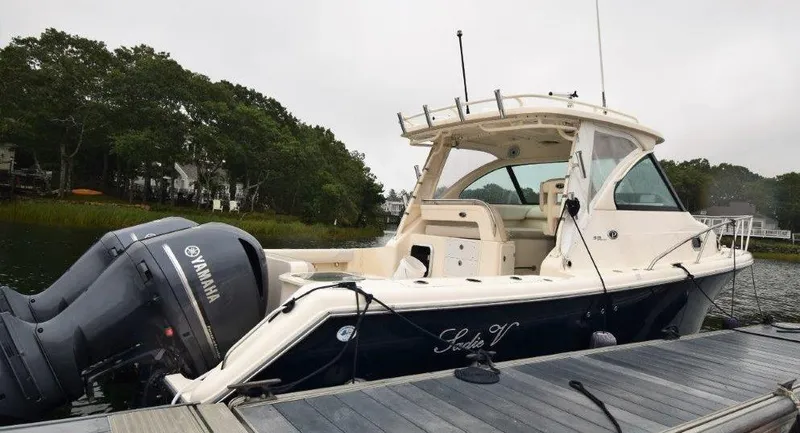 Slide: The Image of 2012 Pursuit 315 Offshore boat docked with Yamaha engines. - 9