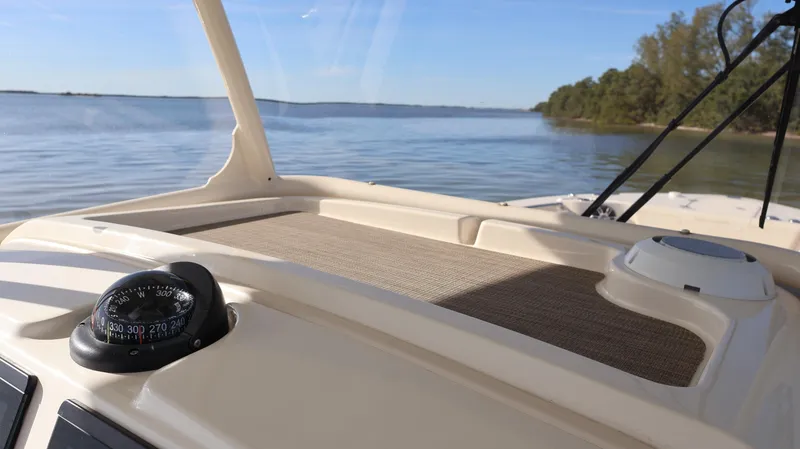 Slide: The Image of 2023 Grady-White 281 Coastal Explorer boat on calm waters, featuring a compass and clear sky. - 34