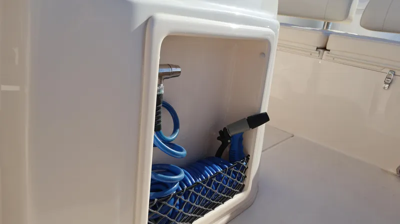 Slide: The Image of Storage compartment with coiled hose on 2023 Grady-White 281 Coastal Explorer boat. - 47
