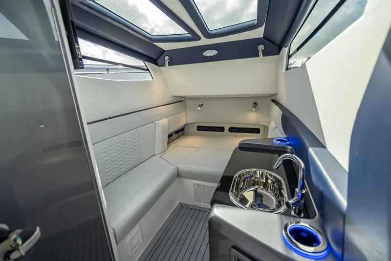 Slide: The Image of Luxurious interior of 2024 Nor-Tech 450 Sport Center Console boat with seating and sink. - 12