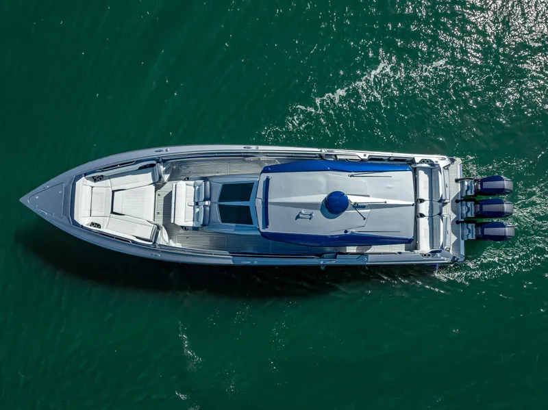 Slide: The Image of 2024 Nor-Tech 450 Sport Center Console boat on water, aerial view. - 14