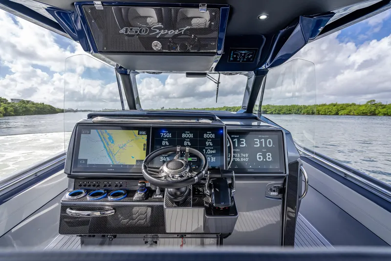 Slide: The Image of 2024 Nor-Tech 450 Sport Center Console dashboard with advanced navigation and controls. - 17