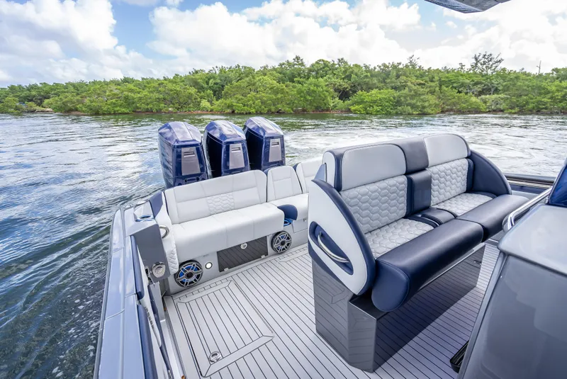 Slide: The Image of 2024 Nor-Tech 450 Sport Center Console boat interior with luxurious seating and triple engines. - 3