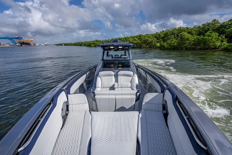 Slide: The Image of 2024 Nor-Tech 450 Sport Center Console boat on a scenic waterway. - 4