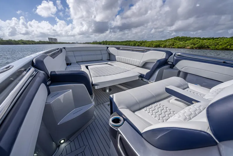 Slide: The Image of 2024 Nor-Tech 450 Sport Center Console boat interior with luxurious seating and scenic water view. - 5