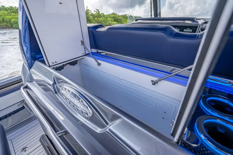 Slide: The Image of 2024 Nor-Tech 450 Sport Center Console interior with open storage compartment and blue accents. - 6