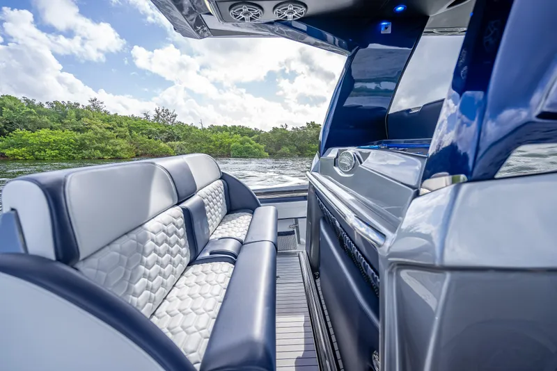 Slide: The Image of 2024 Nor-Tech 450 Sport Center Console interior with luxurious seating and sleek design. - 7