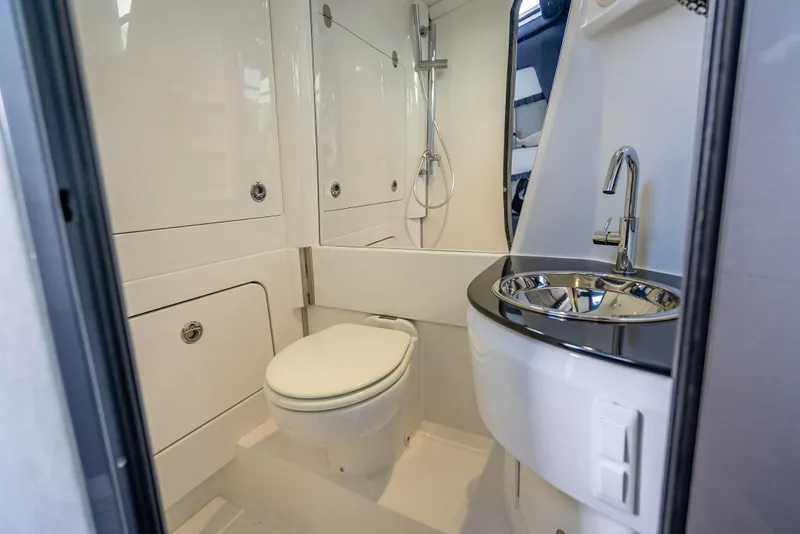Slide: The Image of 2024 Nor-Tech 450 Sport Center Console bathroom with modern fixtures and sleek design. - 8