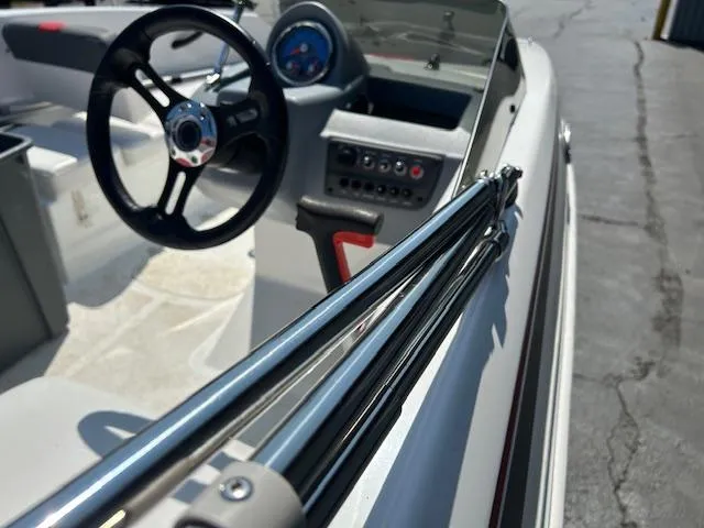 Slide: The Image of 2022 Tahoe T16 boat interior with steering wheel and control panel. - 12