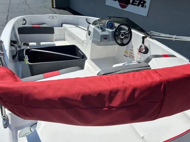Slide: The Image of 2022 Tahoe T16 boat interior with red accents and steering console. - 13