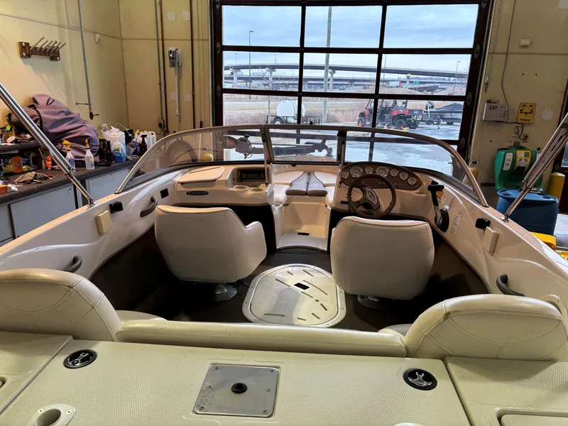 Slide: The Image of 2006 Tahoe Q4 Sport boat interior in a garage, featuring white seats and dashboard. - 5
