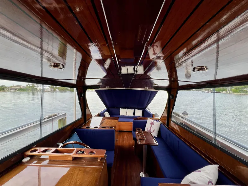 Slide: The Image of Luxurious interior of 2013 Custom O'Neill Craft Tritoon boat with wooden finish and blue seating. - 11
