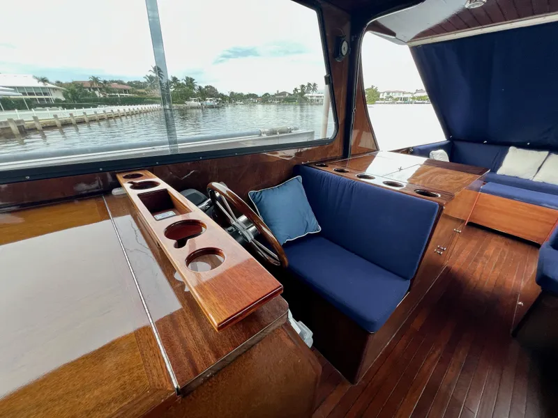 Slide: The Image of Luxurious 2013 Custom O'Neill Craft Tritoon interior with wooden finish and blue seating. - 14