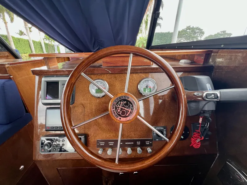 Slide: The Image of Wooden steering wheel of 2013 O'Neill Craft Tritoon boat, featuring control panel and gauges. - 19