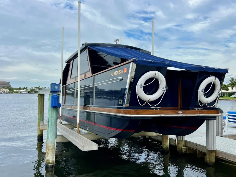 Slide: The Image of Custom 2013 O'Neill Craft Tritoon boat docked with lifebuoys, under a cloudy sky. - 27