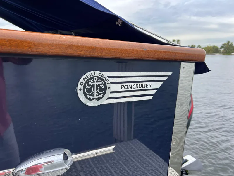 Slide: The Image of Close-up of 2013 O'Neill Craft Tritoon boat logo on water. - 4