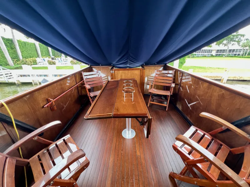 Slide: The Image of Luxurious 2013 O'Neill Craft Tritoon deck with wooden chairs and table under blue canopy. - 7