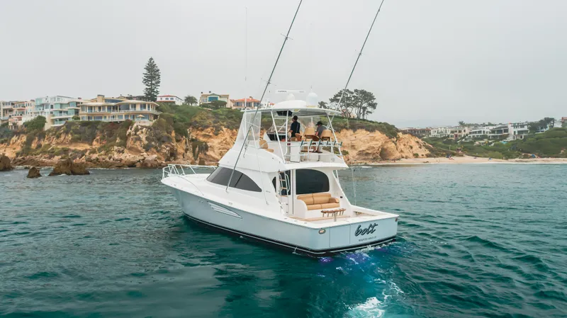 Slide: The Image of Viking 48 Convertible 2017 yacht cruising near rocky coastline. - 0