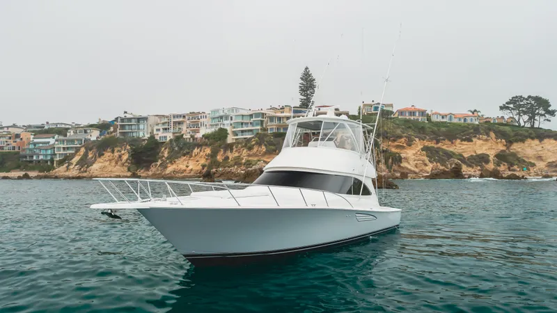 Slide: The Image of 2017 Viking 48 Convertible yacht on scenic coastal waters. - 1