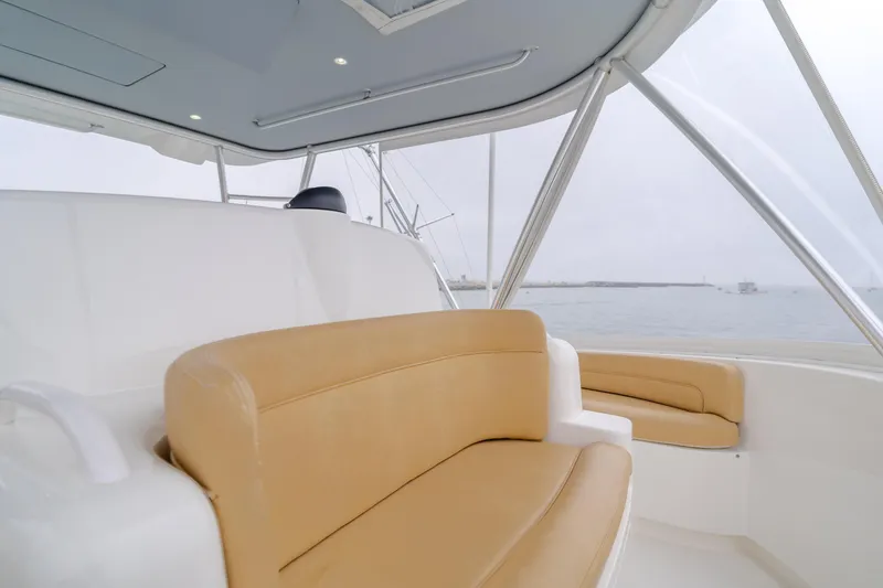 Slide: The Image of Luxurious seating on 2017 Viking 48 Convertible yacht, featuring tan and white upholstery. - 13