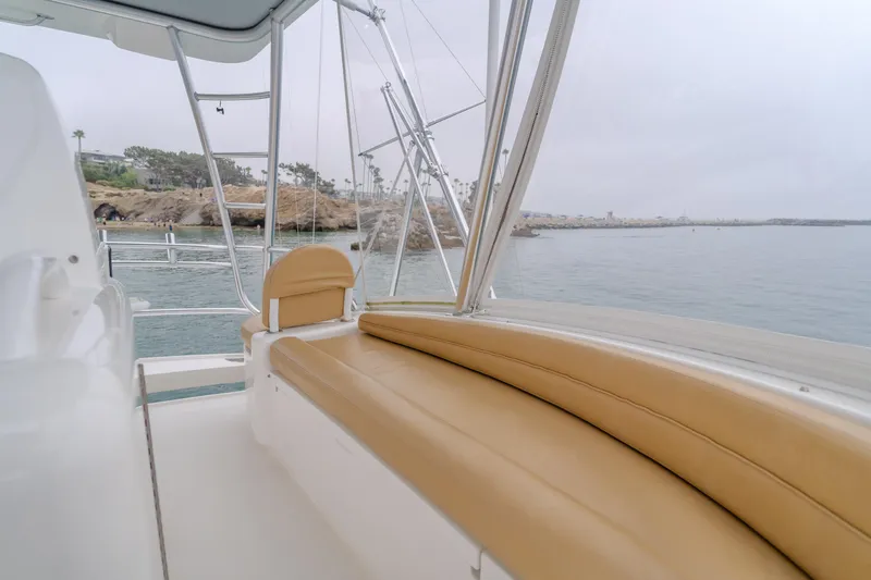 Slide: The Image of 2017 Viking 48 Convertible yacht interior with tan seating, overlooking calm waters. - 15