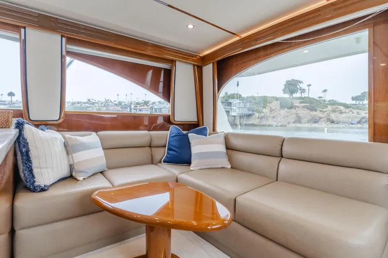 Slide: The Image of Luxurious interior of 2017 Viking 48 Convertible yacht with plush seating and scenic windows. - 25
