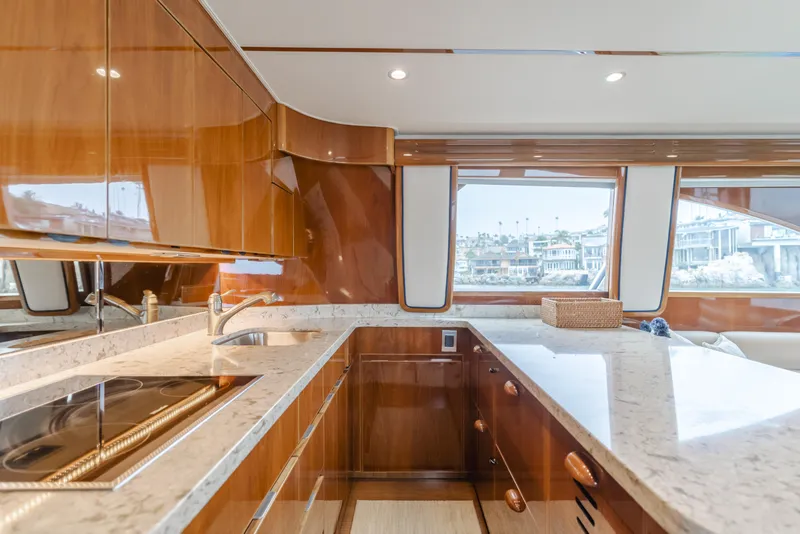 Slide: The Image of Luxurious kitchen interior of 2017 Viking 48 Convertible yacht with wood cabinetry and marble countertops. - 28