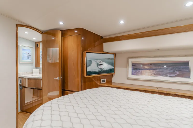 Slide: The Image of Luxurious 2017 Viking 48 Convertible yacht bedroom with elegant wood finishes and modern decor. - 31
