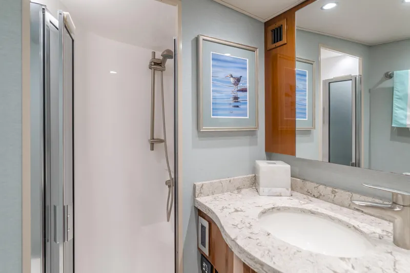Slide: The Image of Luxurious bathroom in 2017 Viking 48 Convertible yacht with modern shower and marble countertop. - 32