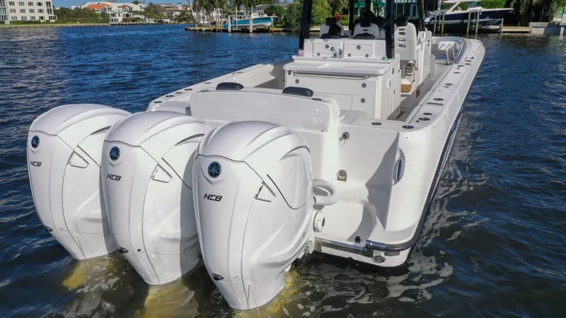 Slide: The Image of 2022 HCB 42 Lujo boat with triple outboard engines on the water. - 14
