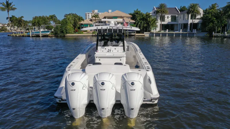 Slide: The Image of 2022 HCB 42 Lujo boat with triple engines on a scenic waterway. - 15
