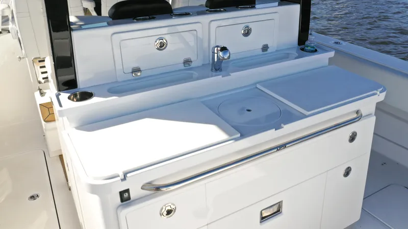 Slide: The Image of HCB 42 Lujo 2022 boat interior with sleek white cabinetry and sink. - 16
