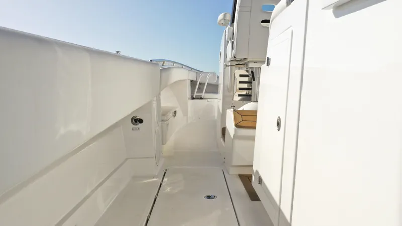 Slide: The Image of 2022 HCB 42 Lujo yacht interior walkway, sleek white design. - 17